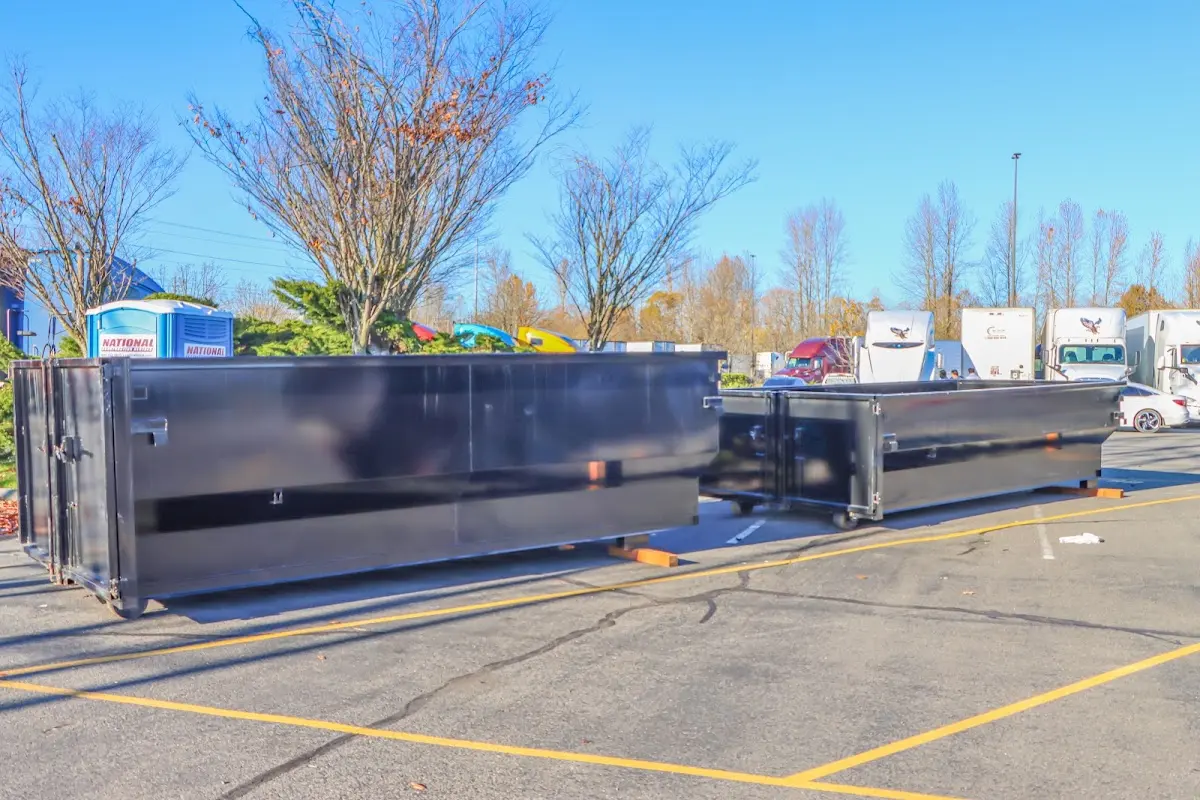 Professional dumpster rental service with roll-off container on residential driveway in Austell